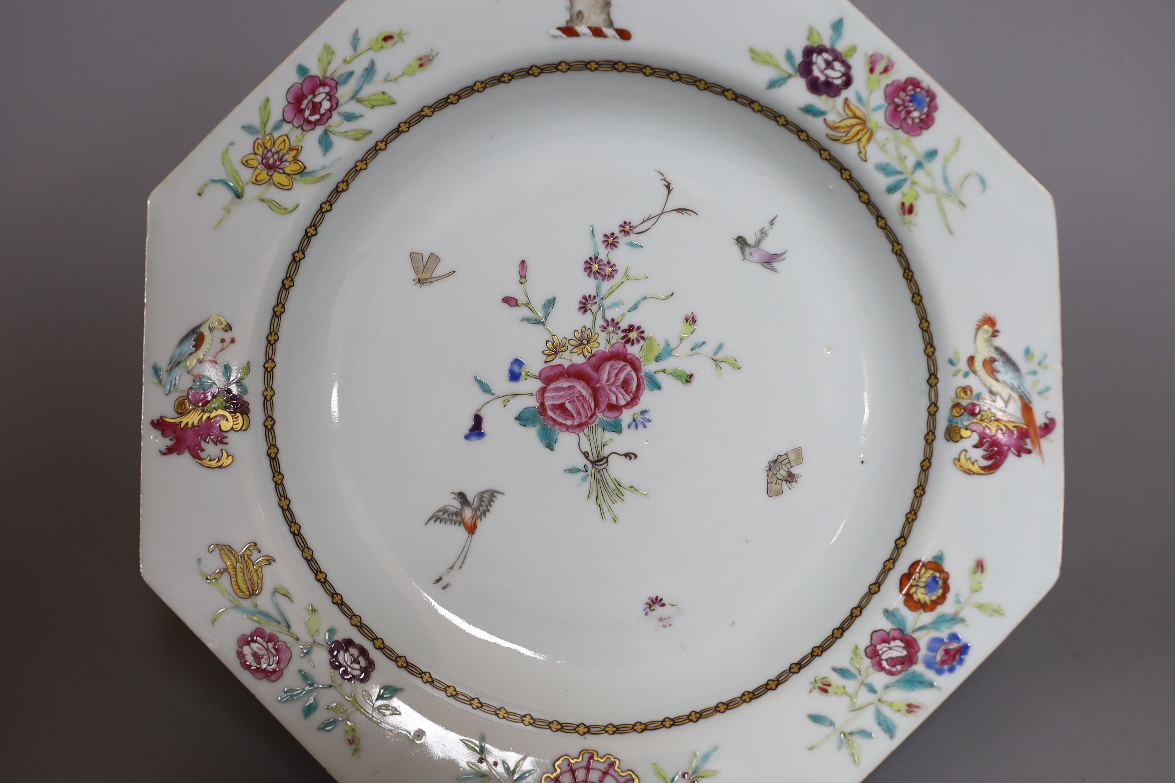 An 18th century Chinese export crested octagonal plate with floral decoration, 21.5cm wide